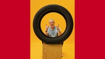 Richard looking throuhg a car tire. 