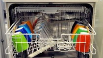 Colourful mugs and plates with basf logo in a dishwasher Colourful mugs and plates with basf logo in a dishwasher