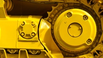 Track drive gear, bulldozer sprocket mechanism, large yellow construction machine with bolts, heavy industry, detail Track drive gear, bulldozer sprocket mechanism, large yellow construction machine with bolts, heavy industry, detail
