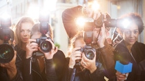 Portrait of paparazzi in a row with cameras and microphone