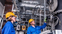 Climate protection is a central component of the BASF strategy. For many years, the company has been continuously reducing its CO2 emissions. For further significant reduction, innovative processes such as methane pyrolysis are developed as part of our Carbon Management R&D Program. In the project funded by the Federal Ministry of Education and Research (Germany), BASF researchers are working on a new reactor concept in which hydrogen can be produced without CO2 emissions. The construction of a test facility is a decisive step towards large-scale implementation. Plant designer Christina Maisel (left) and engineer Bernd Zoels (right) inspect the assembly of the reactor of the test facility at the Verbund site in Ludwigshafen (Germany).