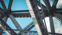 Bridge frame closeup on blue sky background. Horizontal toned image