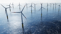 Offshore wind turbines farm on the ocean. Sustainable energy production, clean power. Offshore wind turbines farm on the ocean. Sustainable energy production, clean power.