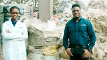 Wecyclers workers and BASF’s Dr. Akintayo Adisa in front of sorted plastics Wecyclers workers and BASF’s Dr. Akintayo Adisa in front of sorted plastics