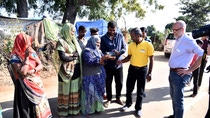 Women dressed in traditional Indian clothing and men together during a photo op with BASF representative for sustainable products
