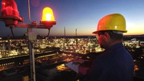 engineer working at BASF production site at night overlooking the city engineer working at BASF production site at night overlooking the city