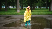 Little boy playing in rainy summer park. Child with umbrella, waterproof coat and boots jumping in puddle and mud in the rain. Kid walking in summer rain Outdoor fun by any weather. happy childhood; Shutterstock ID 1431726590; Jobnummer: 95148411 ; Projekt: CPO Paket; Endkunde: BASF SE, C/K Michelle Serr; Sonstiges: BASF SE, ESI/K Frau Peichl