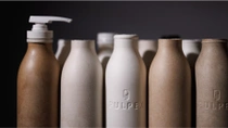 A row of brown and beige eco-friendly bottles made from biodegradable materials. A row of brown and beige eco-friendly bottles made from biodegradable materials.