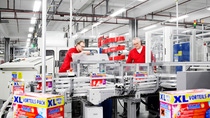 Two men working on Henkel production line making dishwasher tablets