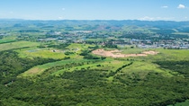 Overview of beautiful landscape with lots of green fields and river flowing through