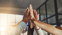Shot of a group of colleagues giving each other a high five Shot of a group of colleagues giving each other a high five