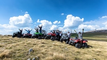 Friends driving off-road with quad bike or ATV and UTV vehicles