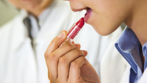 Woman applying lipstick