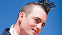 Man with a mohawk smiling