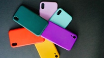 Colourful phone covers displayed in a circle with black background