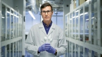 Frontal shot of a scientist in his laboratory holding plastic cutlery in his hands. Frontal shot of a scientist in his laboratory holding plastic cutlery in his hands.