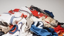 A pile of used sports jerseys in various colors. A pile of used sports jerseys in various colors.