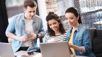 Aspiring man and two ladies smiling sitting at the table; Shutterstock ID 744992392; Thema: Millenials Aspiring man and two ladies smiling sitting at the table; Shutterstock ID 744992392; Thema: Millenials