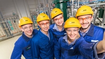 Five BASF employees wearing protective equipment and yellow helmets Five BASF employees wearing protective equipment and yellow helmets
