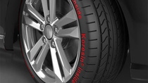 Close up of tire with silver rims with words "Koresin inside" Close up of tire with silver rims with words "Koresin inside"