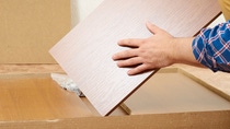 Man opens box with furniture to assemble