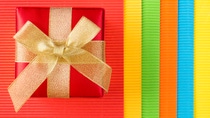 Red gift box on colored corrugated paper background Red gift box on colored corrugated paper background