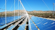Utility-scale solar power plant surrounded by montains.