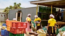 Women workers sort and weigh grain and other food, often from local farmers. Women workers sort and weigh grain and other food, often from local farmers.