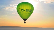 Beautiful landscape with green hot air ballon with BASF logo 