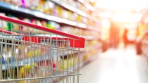 Shopping cart in a blurred grocery store aisle