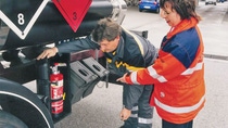 Two people inspecting fire extingusher
