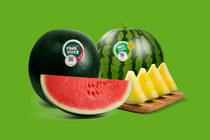 Two whole dark-green Ping Doce watermelons and some red and yellow watermelon slices Two whole dark-green Ping Doce watermelons and some red and yellow watermelon slices