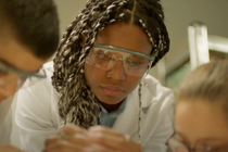 Closeup of a young woman wearing protective glasses.