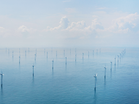 View from above showing several wind turbines in a offshore wind farm 