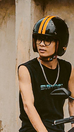 Man sitting on a stationary moped 