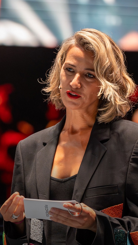 Dr. Christina Dean giving a speech at a convention. Dr. Christina Dean giving a speech at a convention.