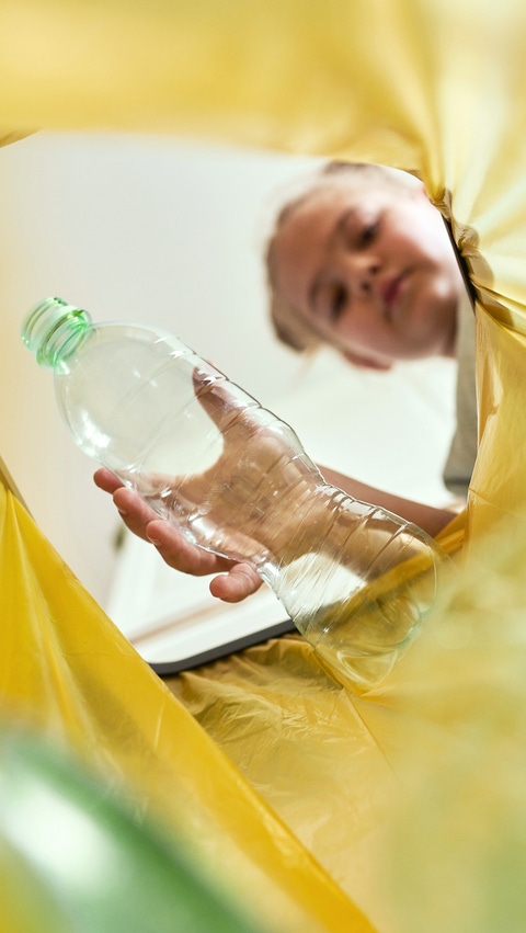 Low angle view of girl throwing a bottle Low angle view of girl throwing a bottle