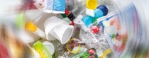 Overhead view of a mass of colored plastic waste including food packaging, disposable cups and bottles – the edges of picture are blurred to give the impression that the waste is spinning in a circle. Overhead view of a mass of colored plastic waste including food packaging, disposable cups and bottles – the edges of picture are blurred to give the impression that the waste is spinning in a circle.