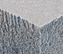 BASF has developed an environmentally friendly, water-based furniture coating which prevents coffee, red wine and mustard from leaving persistent stains on white furniture. While the coating dries, the polymers form a continued phase and prevent liquids with intense colors from penetrating the furniture surface. The white particles in the photo show titanium dioxide which is evenly distributed in the homogeneous film. Magnification 2500:1 (image width 15 cm).