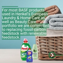 Basket with folded towels and household products such as laundry and cleaning detergents placed in front.