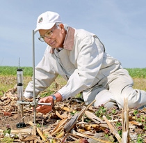 Professor Rattan Lal taking soil measurements in a field. Professor Rattan Lal taking soil measurements in a field.