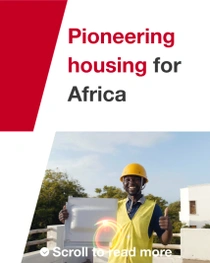 A man wearing a yellow safety vest and hard hat stands outside in front of a building, holding a construction tile. Light swirls appear near the person's hand. The text reads: "Pioneering housing for Africa." A man wearing a yellow safety vest and hard hat stands outside in front of a building, holding a construction tile. Light swirls appear near the person's hand. The text reads: "Pioneering housing for Africa."