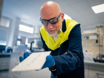 Patrick Keil inspects a painted test panel.