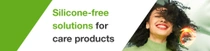 A smiling woman with black curly hair. A light swirl hovers over her hair. The text on the image reads: "Silicone-free solutions for care products."